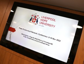 Welcome screen at the 2022 Hope Ecumenical Network Symposium displaying the event title and dates.